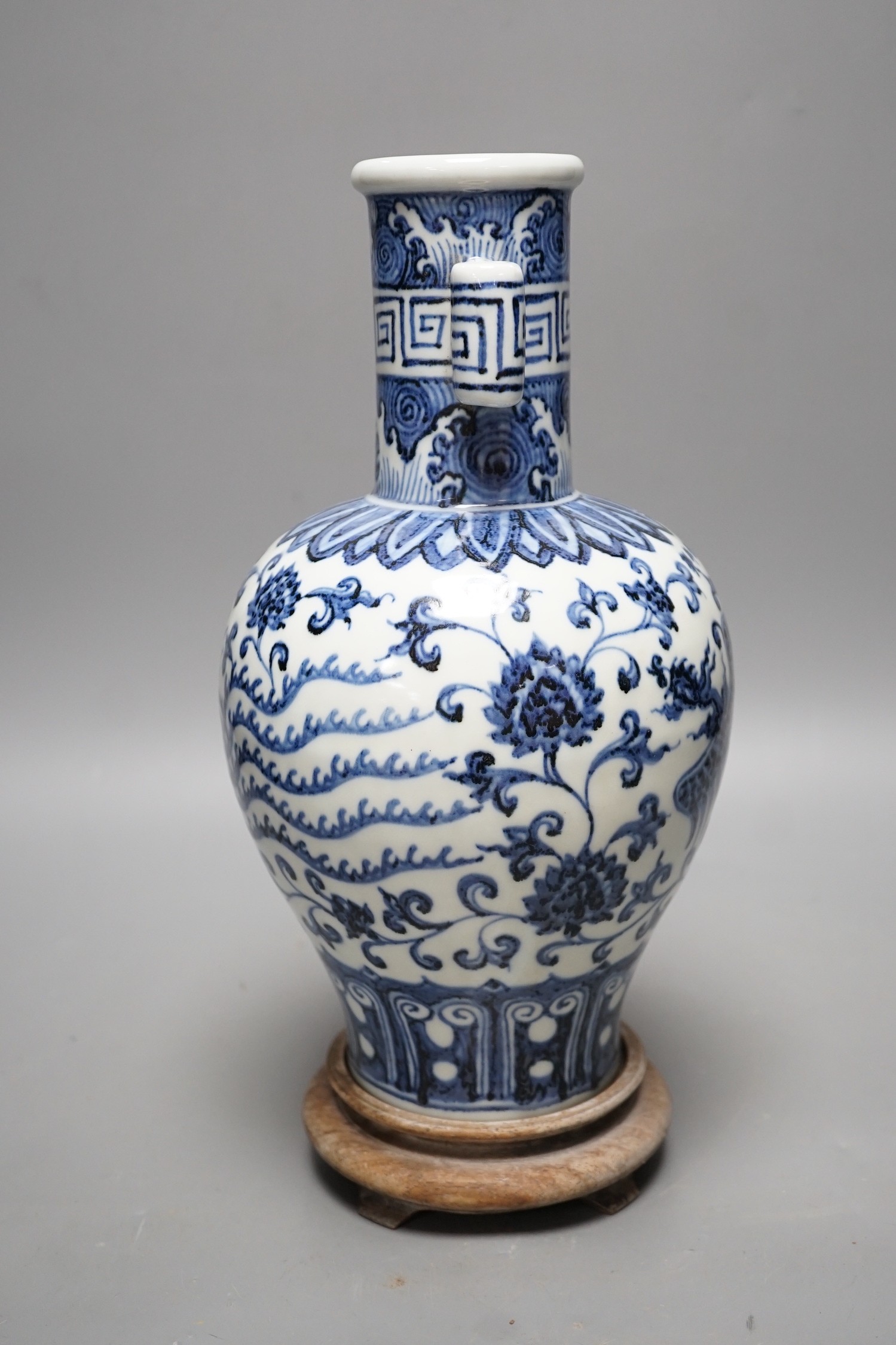 A Chinese blue and white vase on stand, 34cms high